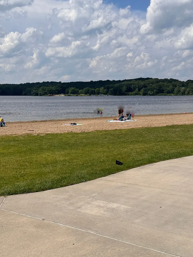 Sandy Martindale Beach beside Kent Lake, with a grassy picnic area and paved path
